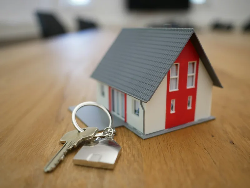 House keys and mortgage agreement on a wooden table — overseas and international property financing guide